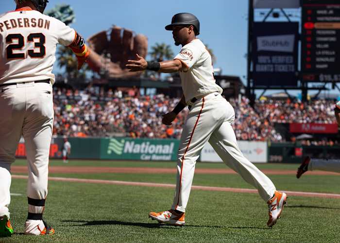 SF Giants first baseman LaMonte Wade Jr. high fives outfielder Joc Pederson